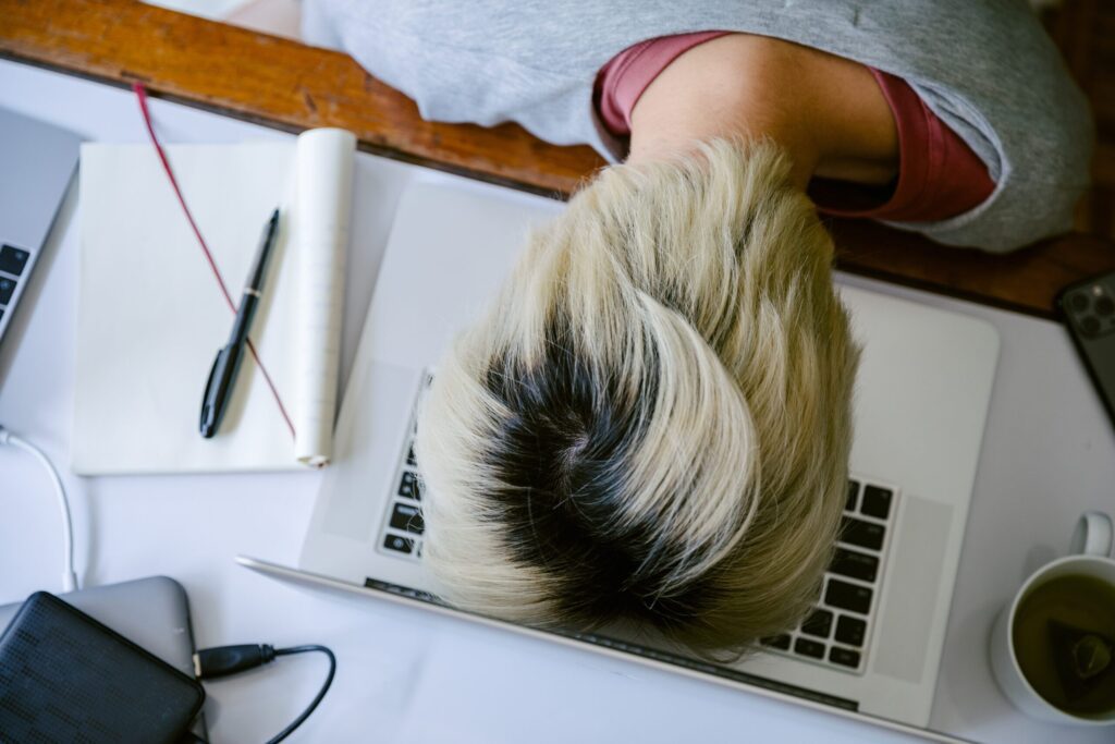 women with head on laptop