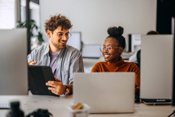Two young colleagues working together at modern office